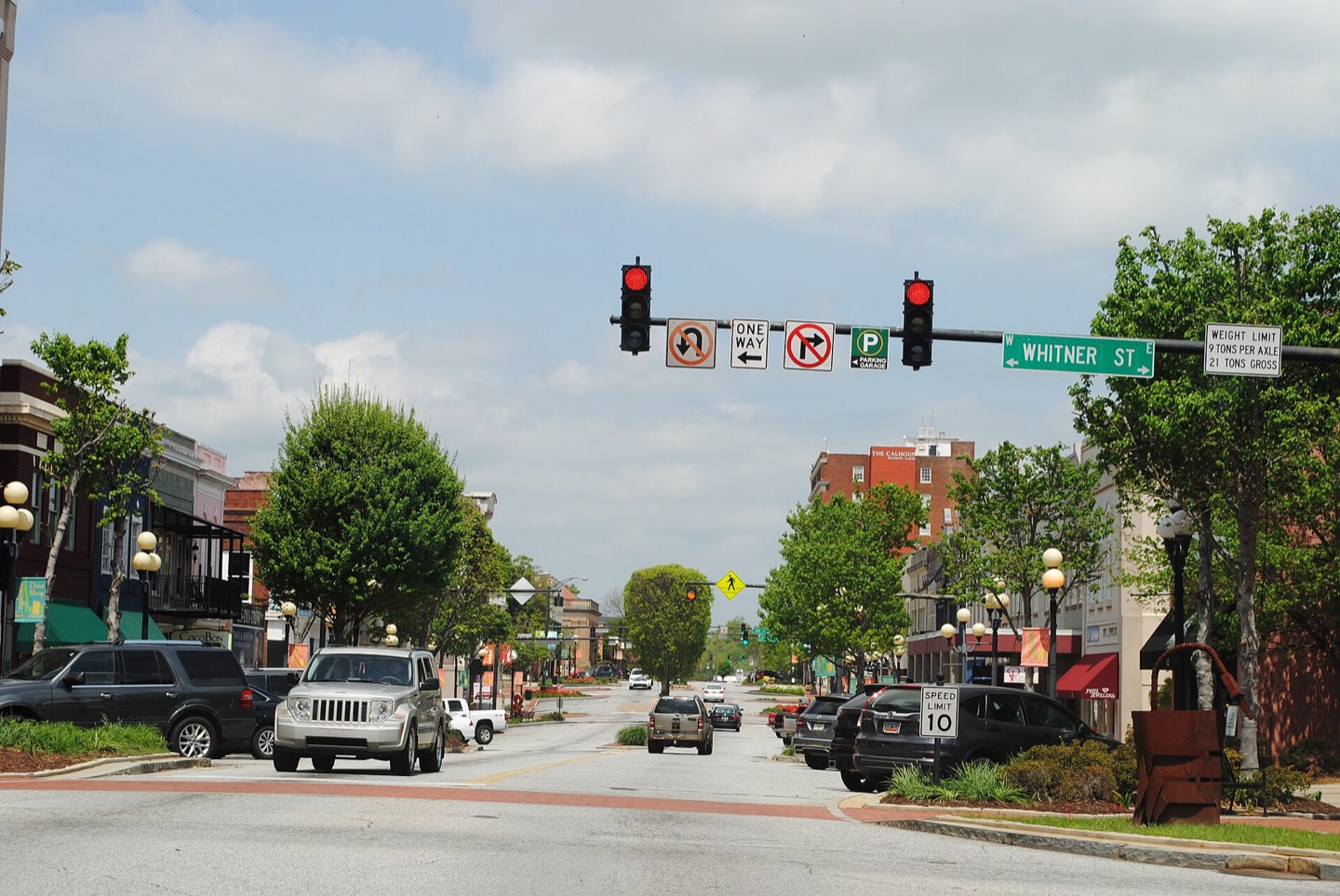 Downtown Anderson looking up Main Street at the Whitner Street crossing, storefronts under shade trees