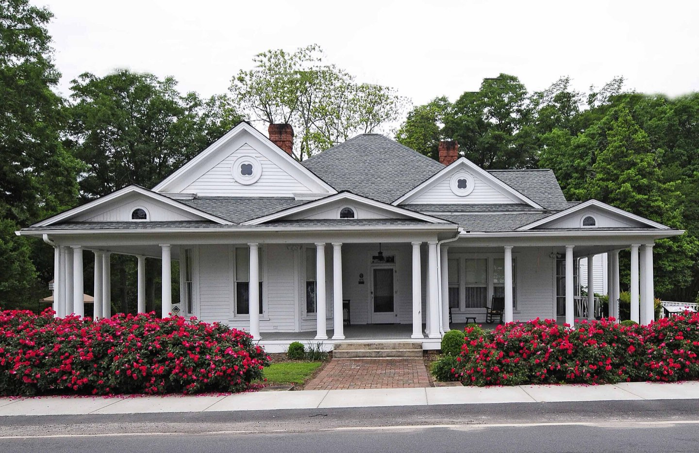 The historic Morgan House in Central, a white-columned home fronted by blooming azaleas