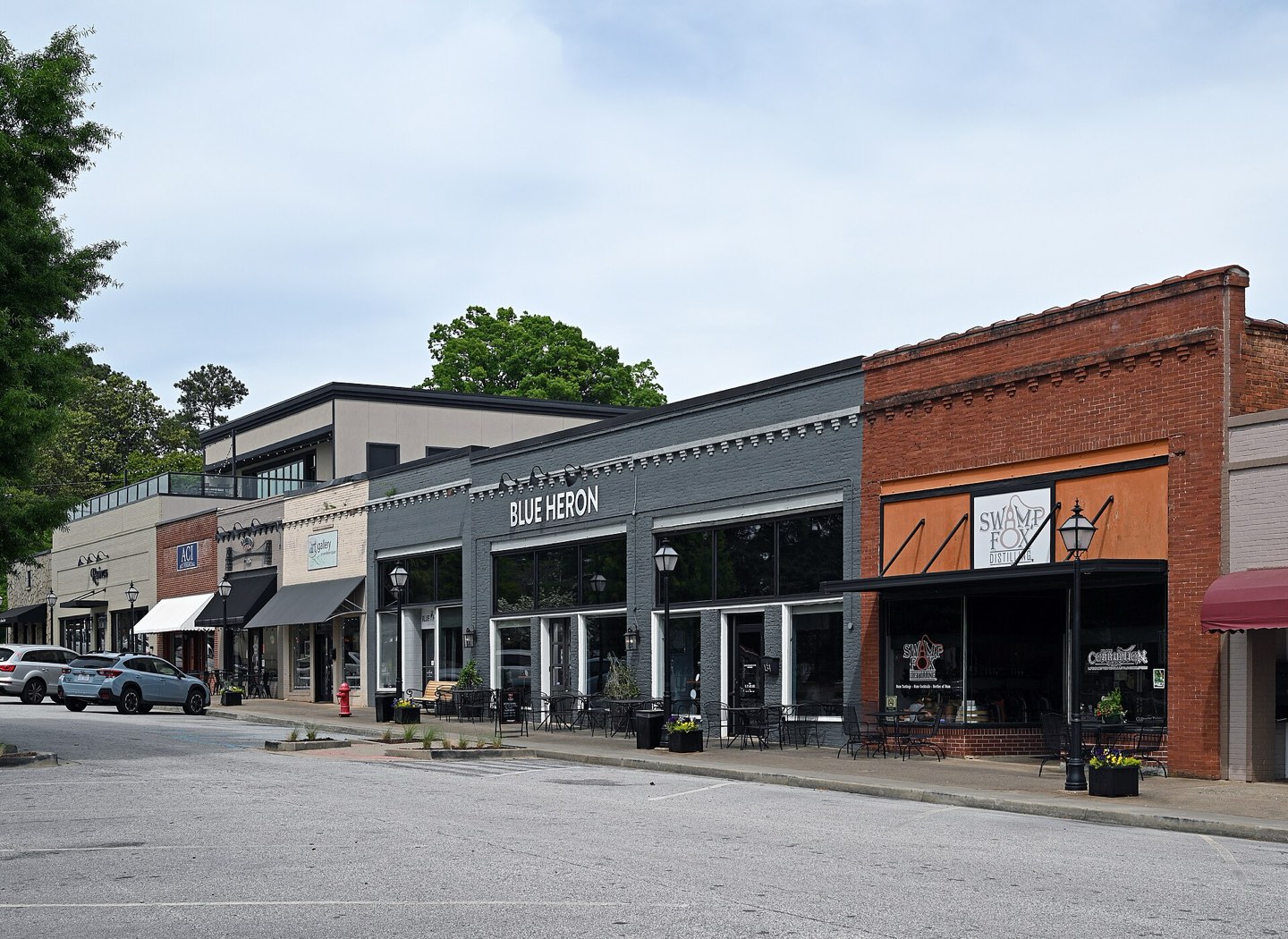 Restored brick storefronts and sidewalk cafe seating along the historic village square in Pendleton